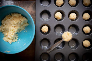 spponing pastry onto muffin tin